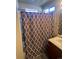 Clean bathroom with shower/tub combo and patterned curtain at 15171 E 118Th Ave, Commerce City, CO 80603