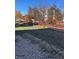 Landscaped backyard with a red fence and gravel area at 15171 E 118Th Ave, Commerce City, CO 80603