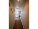Long hallway with decorative wall art and small table at 15171 E 118Th Ave, Commerce City, CO 80603