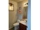 Clean bathroom with single sink vanity, toilet and decorative accents at 15171 E 118Th Ave, Commerce City, CO 80603