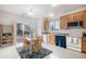 Kitchen with wood cabinets, stainless steel appliances, and a dining area at 20123 E Ithaca Pl, Aurora, CO 80013