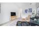 Living room with vaulted ceiling, comfy seating, and a large TV at 20123 E Ithaca Pl, Aurora, CO 80013