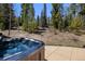 Relax in the outdoor hot tub, surrounded by the peaceful mountain scenery at 312 Corkscrew Dr, Breckenridge, CO 80424