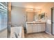 Bathroom boasts double vanity, soaking tub, and shower at 4732 S Coolidge St, Aurora, CO 80016