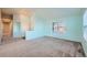 Bright living room with light blue walls and gray carpet at 4732 S Coolidge St, Aurora, CO 80016