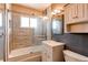 Updated bathroom with a tub and modern vanity at 6930 Birch St, Commerce City, CO 80022