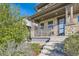 Charming two-story home exterior with stone accents, covered porch, and landscaping at 21541 E 60 Th Ave, Aurora, CO 80019