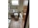 Bathroom with tiled floor, white toilet and sink, and bathtub at 420 E 45Th Ave, Denver, CO 80216