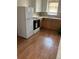 Cozy kitchen with wood-look flooring, white appliances, and wood cabinets at 420 E 45Th Ave, Denver, CO 80216