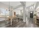 Bright dining area with hardwood floors and a view into the kitchen and living room at 16351 Umpire St, Hudson, CO 80642