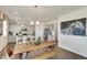 Modern kitchen features gray cabinets, an island, and a dining area at 43195 Merion Hills Ct, Elizabeth, CO 80107