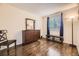 Bright bedroom featuring hardwood floors and a built-in dresser at 6890 W Mississippi Ave # D, Lakewood, CO 80226