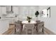 Bright dining area with wood table and six chairs, adjacent to kitchen at 7267 Prairie Sage Pl, Littleton, CO 80125