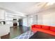 Open concept kitchen and dining area with orange couch and hardwood floors at 9078 E Lehigh Ave, Denver, CO 80237