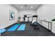 Well-equipped home gym with various exercise machines and mats at 6123 Buffalo Run, Littleton, CO 80125