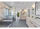 Luxurious bathroom with double vanity, soaking tub, and glass shower at 6123 Buffalo Run, Littleton, CO 80125