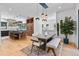 Open concept kitchen and dining area with island and modern light fixtures at 6123 Buffalo Run, Littleton, CO 80125