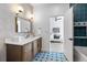 Modern bathroom with updated vanity and patterned tile floor at 6123 Buffalo Run, Littleton, CO 80125