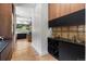Modern butler's pantry with wine rack, custom cabinetry, and granite countertops at 6123 Buffalo Run, Littleton, CO 80125