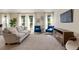 Living room with neutral colored couch and blue accent chairs at 1150 Inca St # 27, Denver, CO 80204