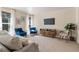 Living room with neutral colored couch and blue accent chairs at 1150 Inca St # 27, Denver, CO 80204