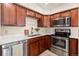 Well-equipped kitchen with stainless steel appliances and wood cabinetry at 1150 Inca St # 27, Denver, CO 80204