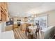 Kitchen with light wood cabinets, island, and dining area at 1265 Button Rock Dr, Longmont, CO 80504