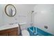 Bathroom with blue bathtub, toilet and wood vanity at 1340 Daphne St, Broomfield, CO 80020