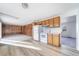 Kitchen with light wood cabinets, white appliances, and vinyl flooring at 1340 Daphne St, Broomfield, CO 80020