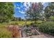 Park-like setting with a creek, lush vegetation, and walking paths at 1340 Daphne St, Broomfield, CO 80020