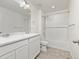 Bathroom with double sinks, bathtub, and shower at 109 Racer St, Bennett, CO 80102