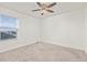Simple bedroom with window and ceiling fan at 109 Racer St, Bennett, CO 80102