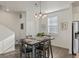 Dining area with four-seat table and modern light fixture at 109 Racer St, Bennett, CO 80102