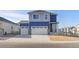 Two-story house with blue and gray siding, two-car garage, and landscaped yard at 109 Racer St, Bennett, CO 80102
