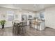 Modern kitchen with white cabinets, granite countertops, and stainless steel appliances at 109 Racer St, Bennett, CO 80102