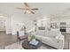 Open living room with hardwood floors and a view of the kitchen at 109 Racer St, Bennett, CO 80102