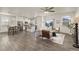 Open living space with hardwood floors, a ceiling fan, and neutral decor at 109 Racer St, Bennett, CO 80102