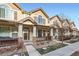 Two story townhome with front porch, landscaping, and satellite dish at 1456 Turnberry Dr, Castle Rock, CO 80104