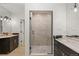 Bathroom with a walk-in shower, dual vanities, and modern fixtures at 5044 Mcclure Ln, Castle Rock, CO 80108