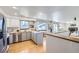 Modern kitchen boasts stainless steel appliances and butcher block island at 4828 S Owens Way, Littleton, CO 80127