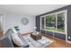 Living room with gray couch, coffee table, and large window with street view at 9927 E 7Th Ave, Aurora, CO 80010