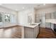 Modern kitchen with island, stainless steel appliances, and hardwood floors at 487 Interlocken Blvd # 102, Broomfield, CO 80021