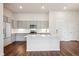 Modern kitchen with island, stainless steel appliances, and hardwood floors at 487 Interlocken Blvd # 102, Broomfield, CO 80021