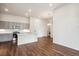Open living room with hardwood floors and kitchen island at 487 Interlocken Blvd # 102, Broomfield, CO 80021