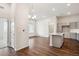 Open living area with hardwood floors and kitchen access at 487 Interlocken Blvd # 102, Broomfield, CO 80021