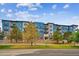 Attractive exterior of a modern apartment building with landscaping at 487 Interlocken Blvd # 102, Broomfield, CO 80021