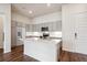 Modern kitchen with island, stainless steel appliances, and hardwood floors at 487 Interlocken Blvd # 102, Broomfield, CO 80021