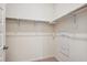 Walk-in closet with double hanging rods and neutral walls at 487 Interlocken Blvd # 102, Broomfield, CO 80021