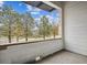 Private balcony overlooking trees and a roadway at 487 Interlocken Blvd # 102, Broomfield, CO 80021