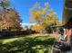 Large backyard with mature trees and a wooden deck at 12484 E Alaska Ave, Aurora, CO 80012